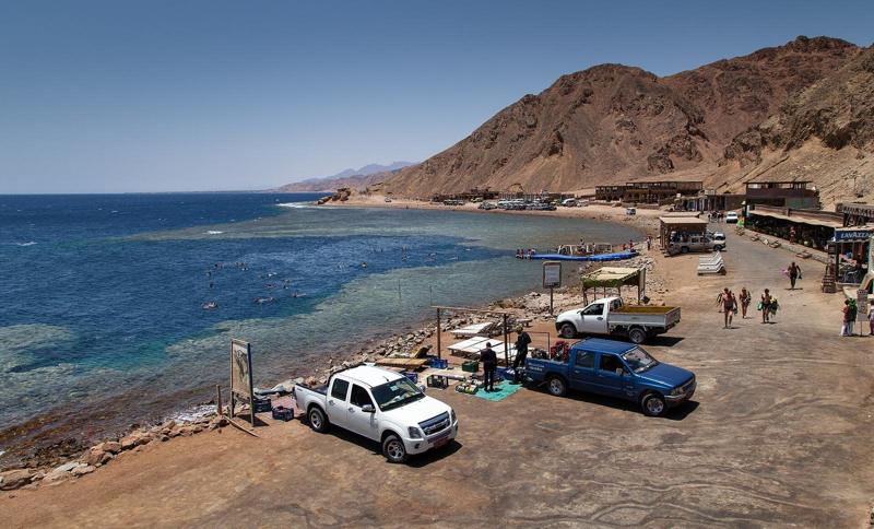 The Blue Hole at Dahab, with the reef edge and the cafes on the shore