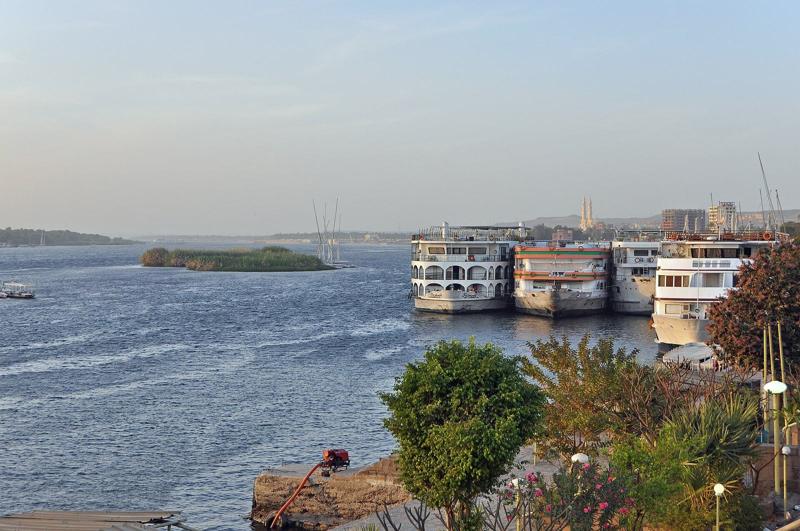 Nile cruise boats moored along the riverbank